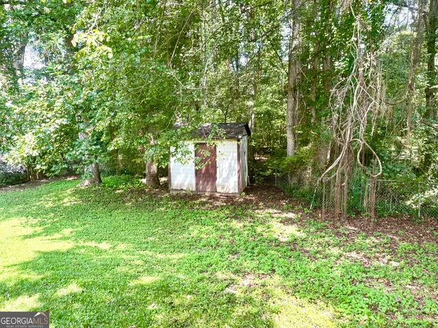 a backyard of a house with lots of green space and fountain