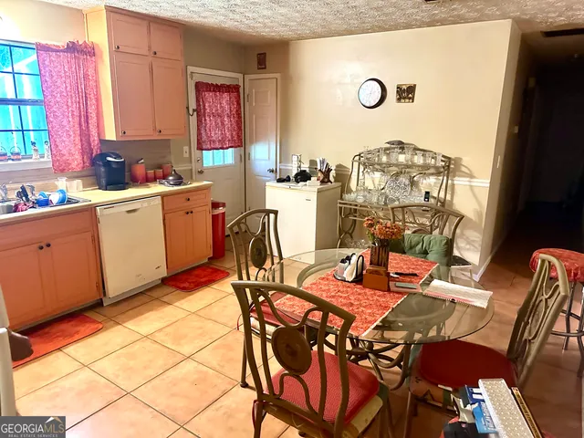 a view of a dining room with furniture and window