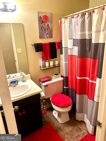 a bathroom with a sink toilet vanity and tub