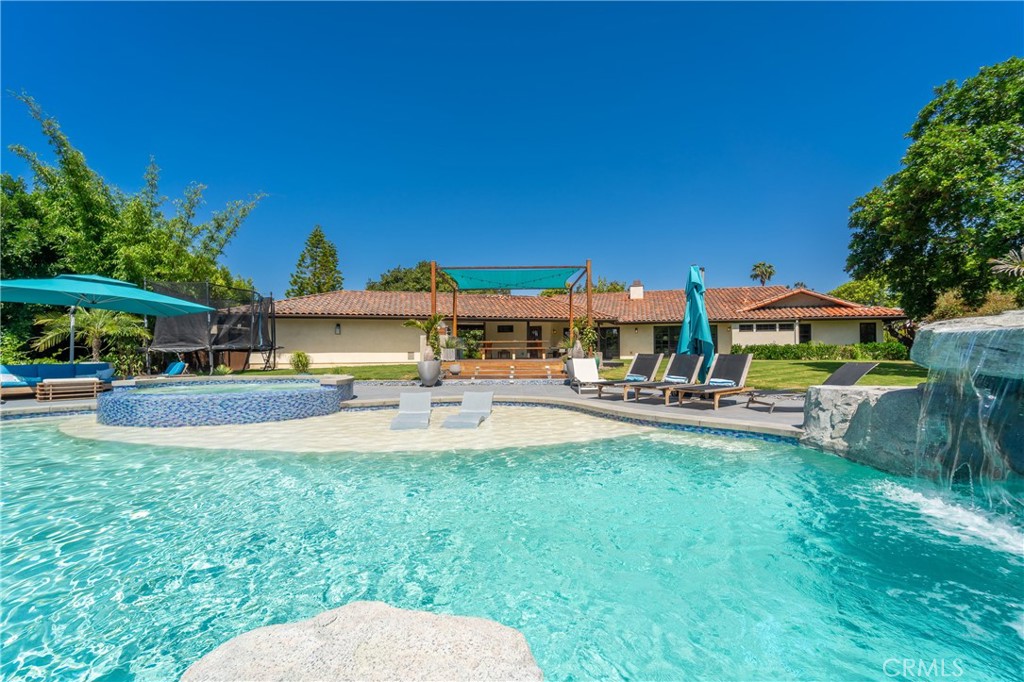 7337 La Soldadera Rancho Santa Fe, CA 92067 - Photo 45 of 60 a view of a swimming pool with lawn chairs and a big yard