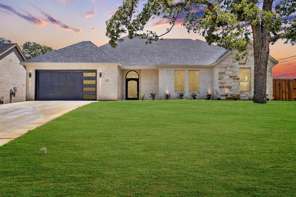 705 Ross Trail Arlington, TX 76012 - Photo 1 of 1 a front view of a house with a yard and garage