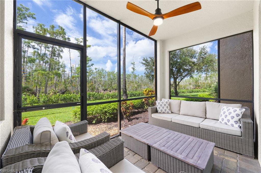 9715 Acqua Court, Unit 116 Naples, FL 34113 - Photo 17 of 43 a living room with furniture and a large window