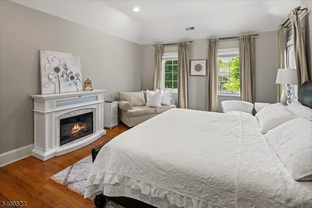 a bedroom with a bed and a fireplace