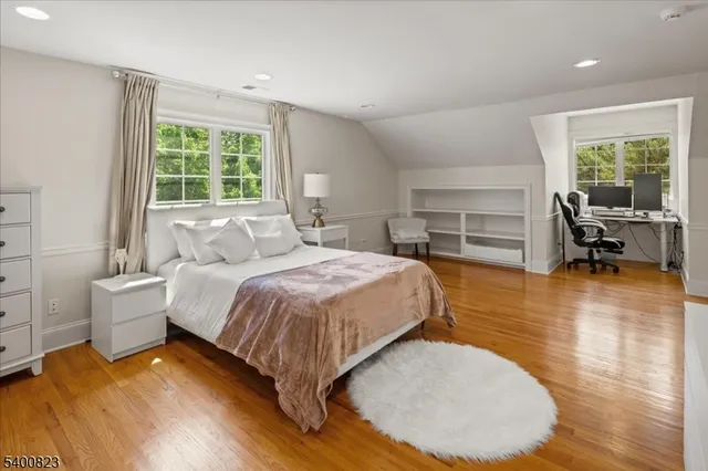 a bed room with a bed and a chair