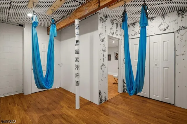 a view of a hallway with wooden floor and entryway