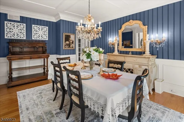 a view of a dining room with furniture and chandelier