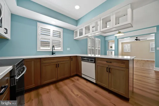 a kitchen with a sink window and cabinets