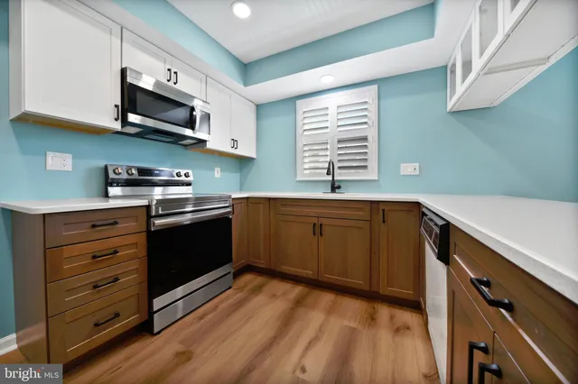 a kitchen with stainless steel appliances a refrigerator and a stove top oven