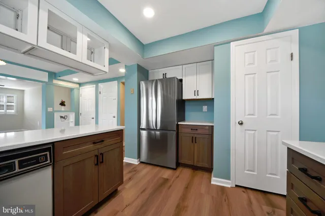 a kitchen with stainless steel appliances granite countertop a sink a stove and a refrigerator