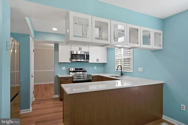 a kitchen with a sink a stove and cabinets