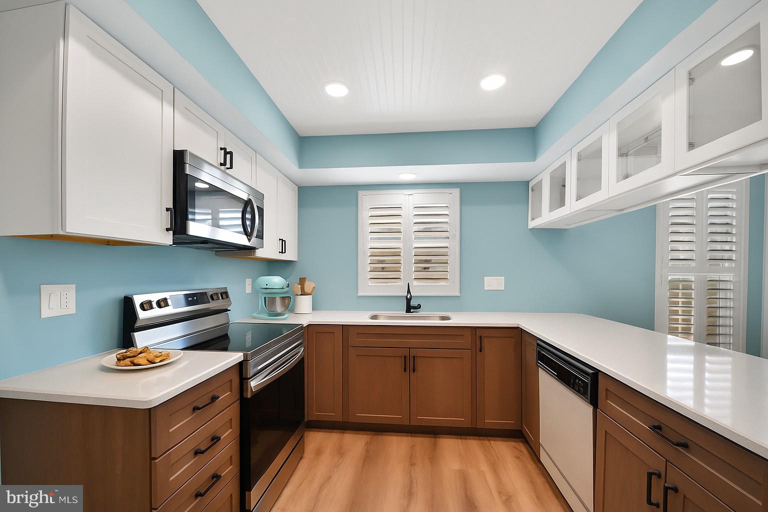 9729 Denrob Court Baltimore, MD 21234 - Photo 16 of 58 a kitchen with a sink a stove and cabinets