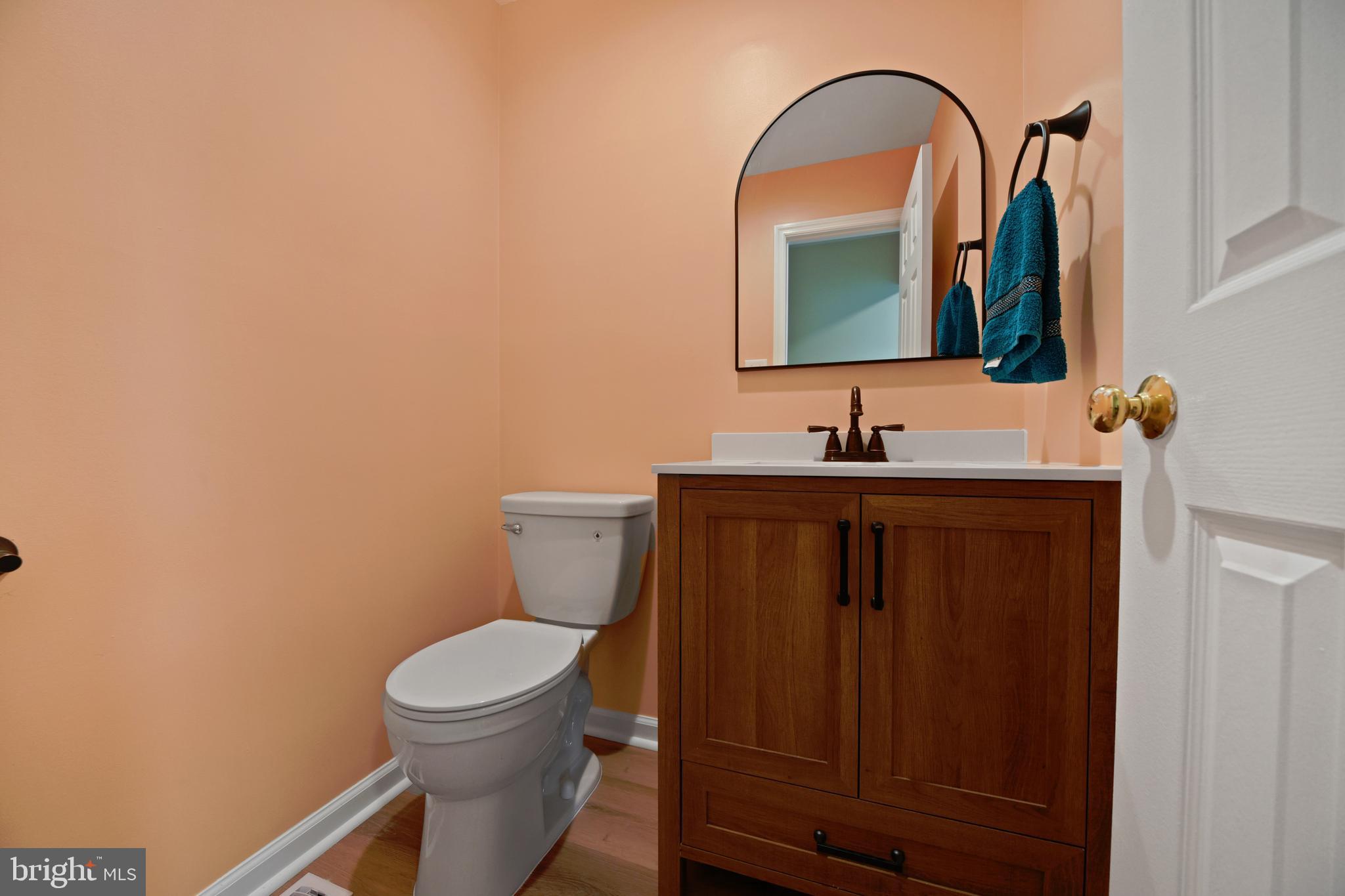 9729 Denrob Court Baltimore, MD 21234 - Photo 23 of 58 a bathroom with a toilet sink and mirror