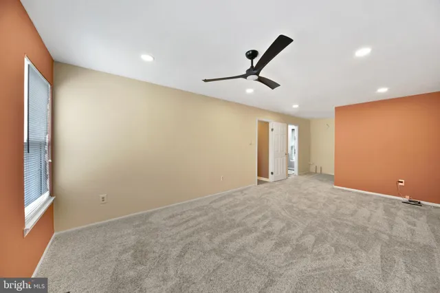 a bedroom with a large bed and a large window