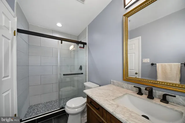 a view of a big room with a ceiling fan and a window