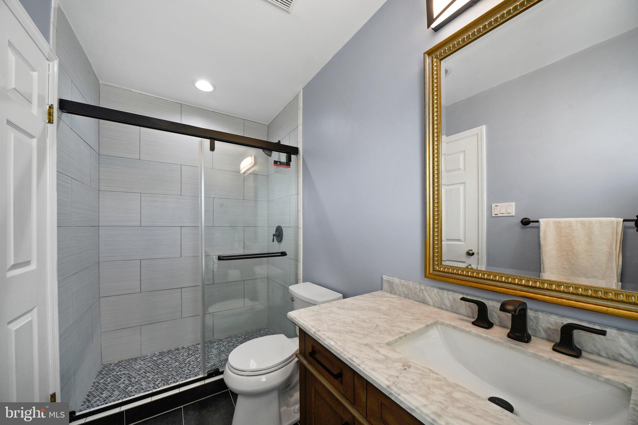 9729 Denrob Court Baltimore, MD 21234 - Photo 30 of 58 a bathroom with a granite countertop sink toilet and shower