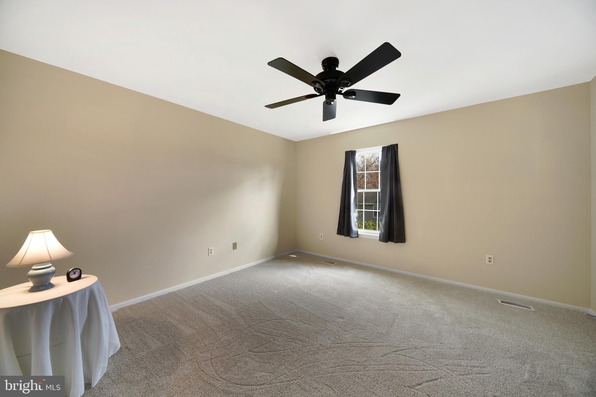 9729 Denrob Court Baltimore, MD 21234 - Photo 31 of 58 a view of a big room with a ceiling fan and a window