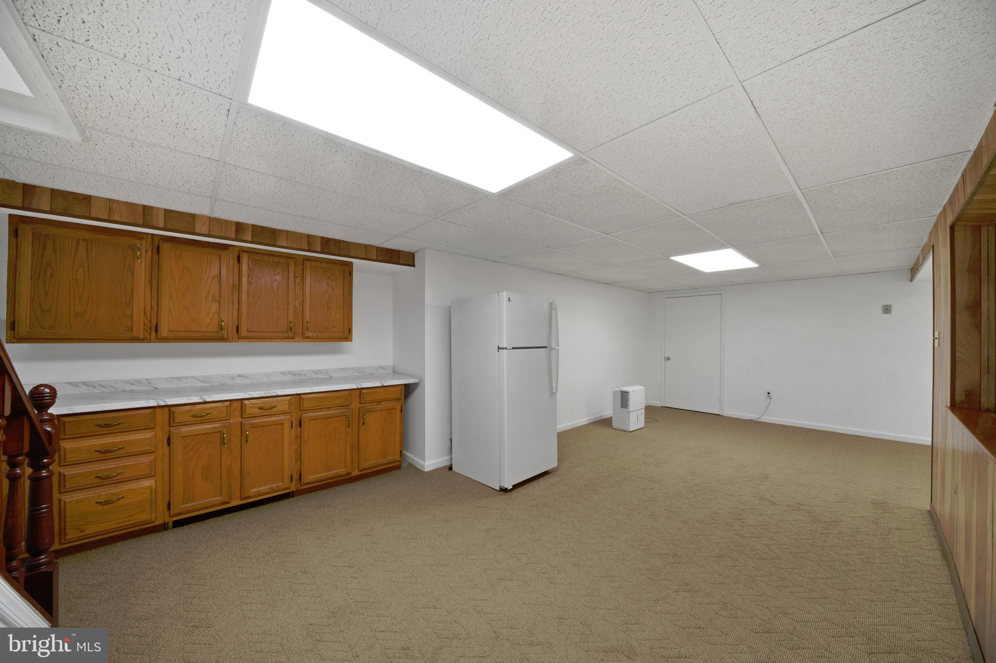 9729 Denrob Court Baltimore, MD 21234 - Photo 42 of 58 a view of an empty room with wooden floor and windows