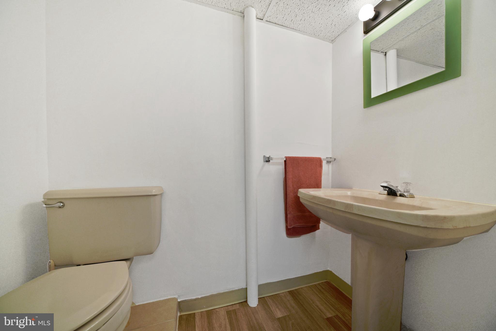 9729 Denrob Court Baltimore, MD 21234 - Photo 45 of 58 a bathroom with a sink a toilet and mirror