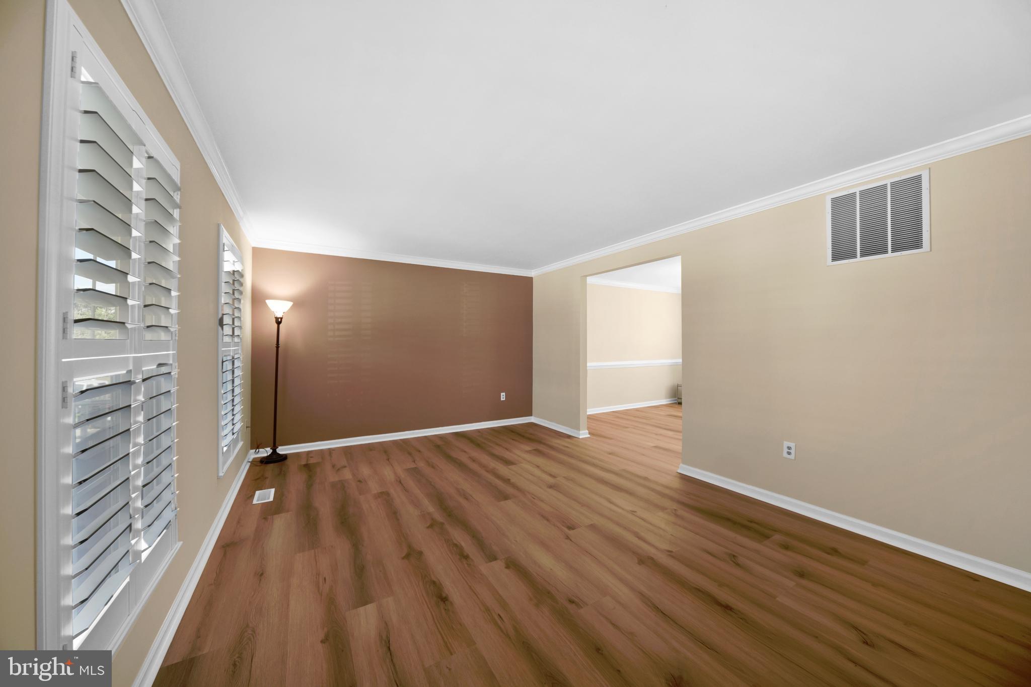 9729 Denrob Court Baltimore, MD 21234 - Photo 5 of 58 a view of an empty room with wooden floor and a window
