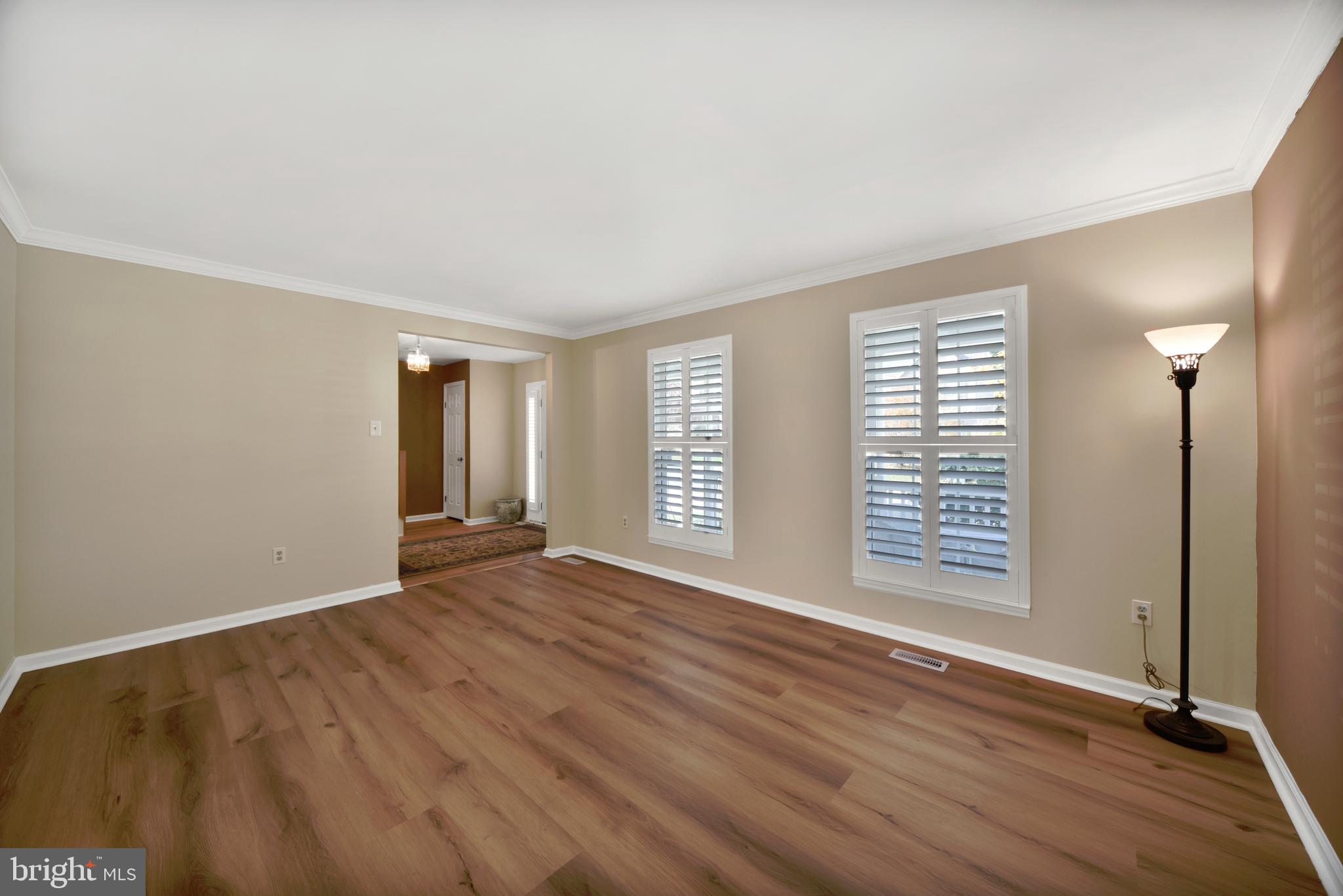 9729 Denrob Court Baltimore, MD 21234 - Photo 6 of 58 an empty room with wooden floor and windows