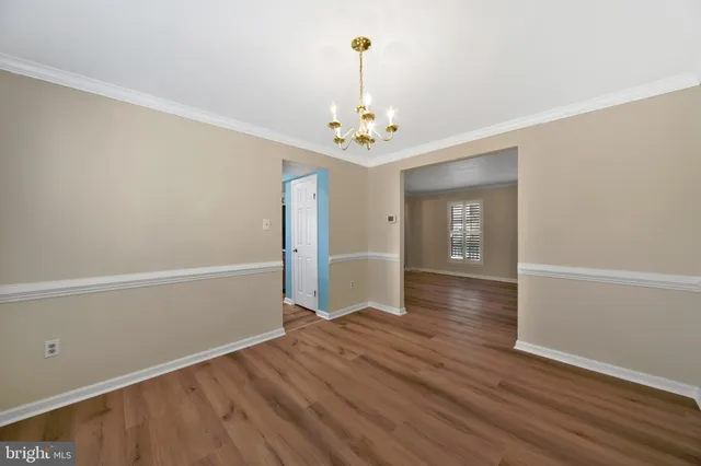 a view of a a dining room with furniture window and wooden floor