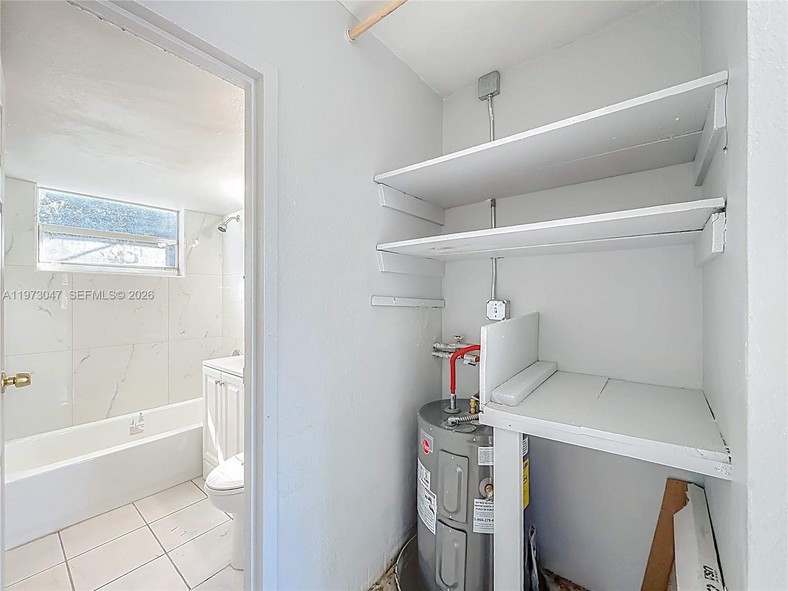 2408 Northwest 8th Street Pompano Beach, FL 33069 - Photo 19 of 24 a bathroom with a bathtub and toilet