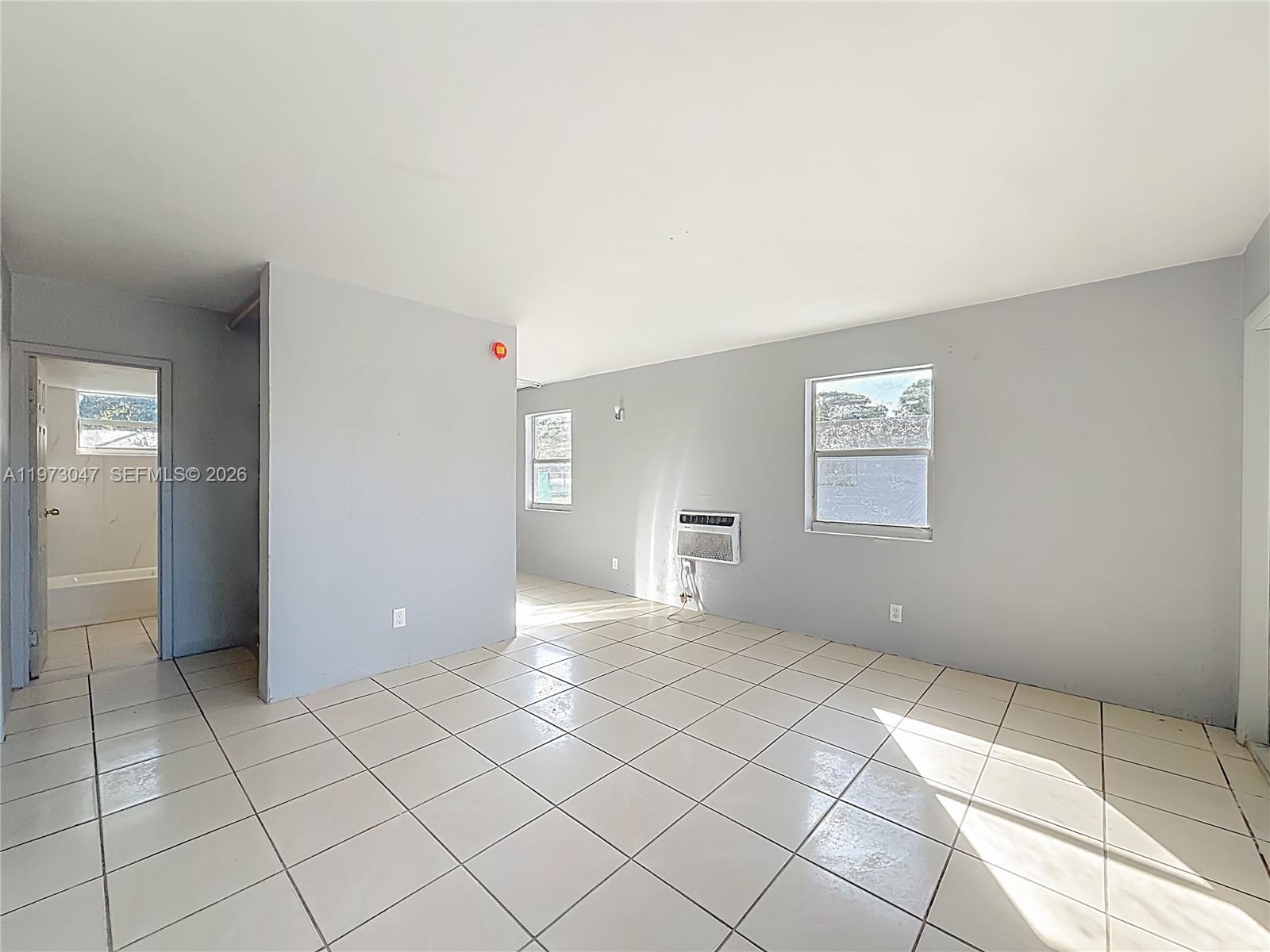 2408 Northwest 8th Street Pompano Beach, FL 33069 - Photo 5 of 24 a view of an empty room and window