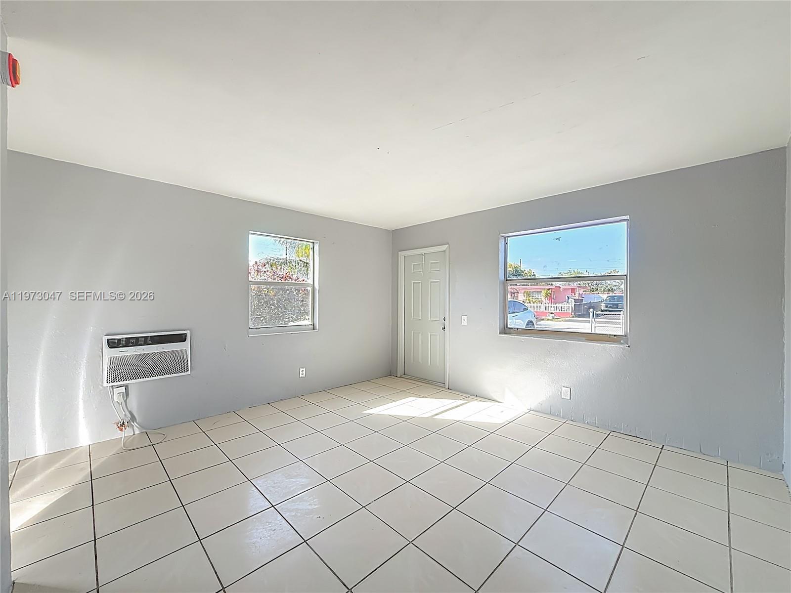 2408 Northwest 8th Street Pompano Beach, FL 33069 - Photo 6 of 24 a view of an empty room and window