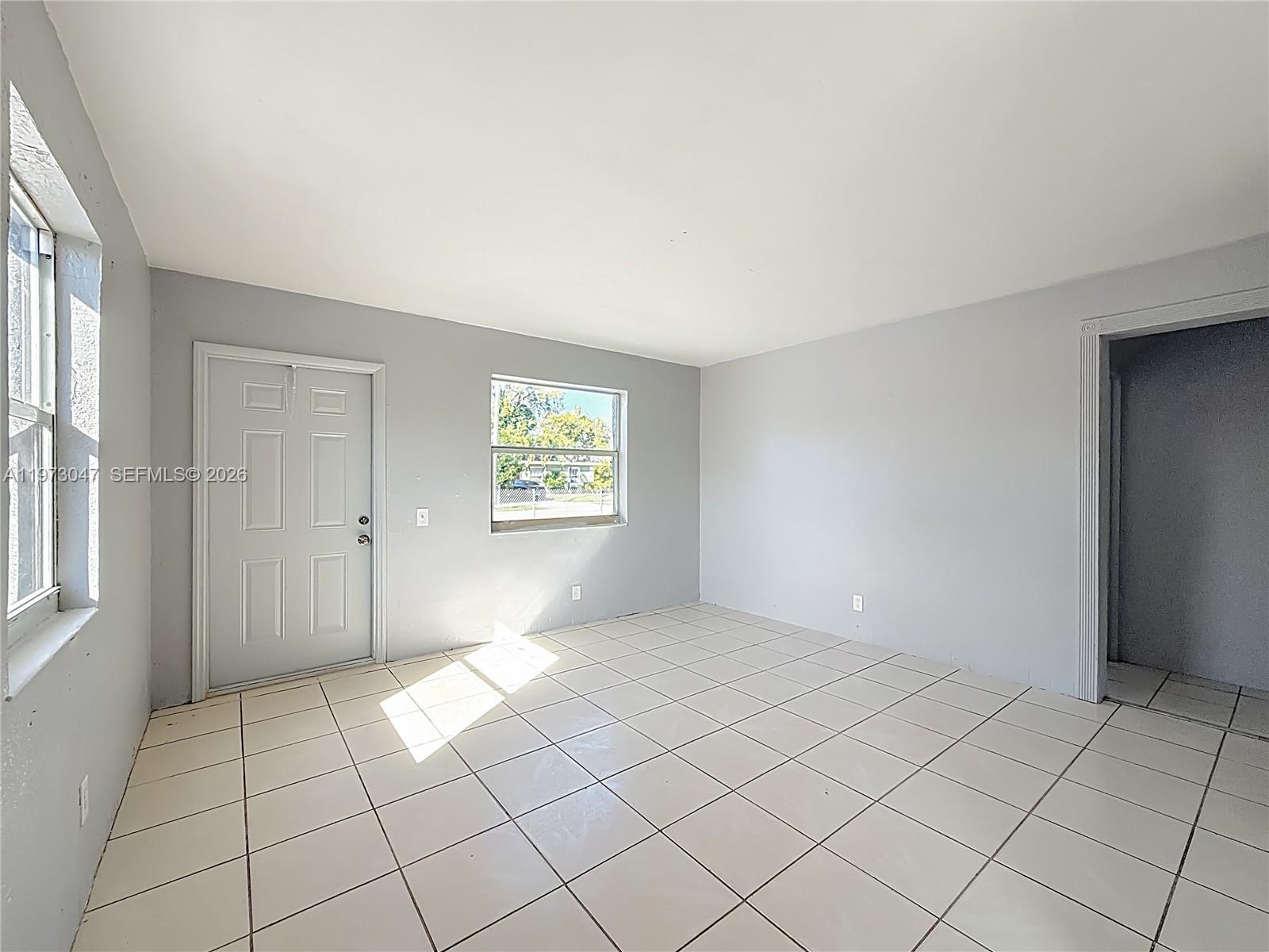2408 Northwest 8th Street Pompano Beach, FL 33069 - Photo 7 of 24 an empty room with windows