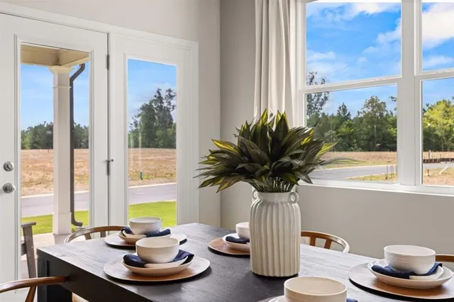a dining room with furniture a rug and wooden floor