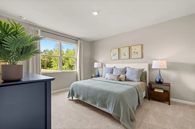 a bedroom with a bed and a potted plant