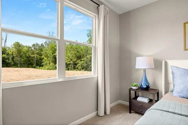 a bedroom with a bed and a lamp