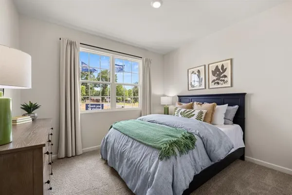 a bedroom with a bed and painting on the wall