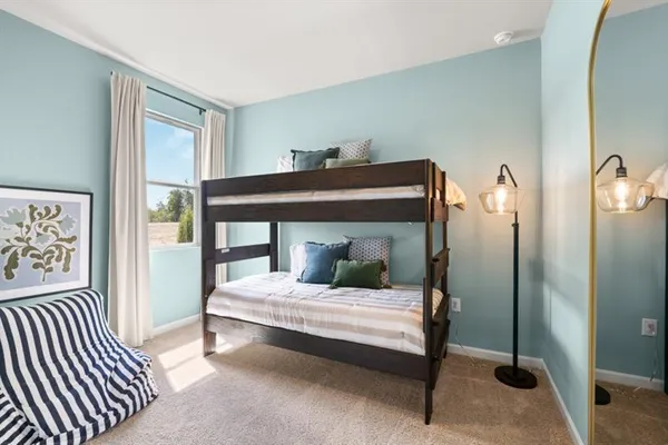 a bedroom with two beds and painted walls