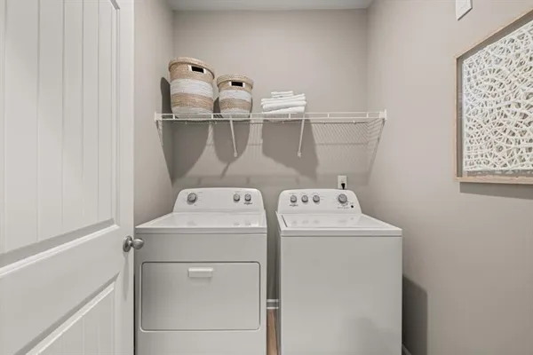 a kitchen with stainless steel appliances a dining table chairs stove microwave and cabinets