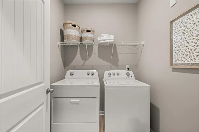 a kitchen with stainless steel appliances a dining table chairs stove microwave and cabinets