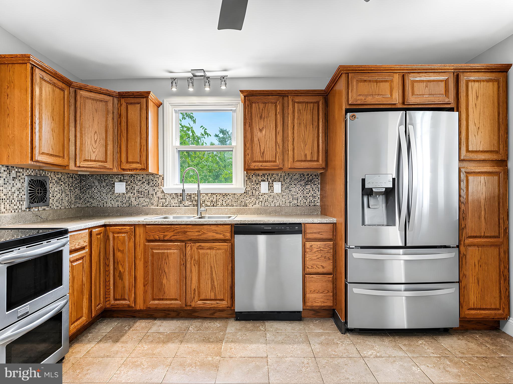 17248 Gum Landing Road St. Inigoes, MD 20684 - Photo 15 of 56 a kitchen with a refrigerator and a sink