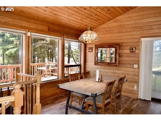 34518 Mutts Way Gold Beach, OR 97444 - Photo 31 of 40 a dining room with furniture a chandelier and wooden floor