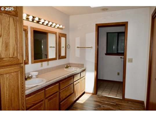 34518 Mutts Way Gold Beach, OR 97444 - Photo 32 of 40 a bathroom with a sink a mirror and a shower