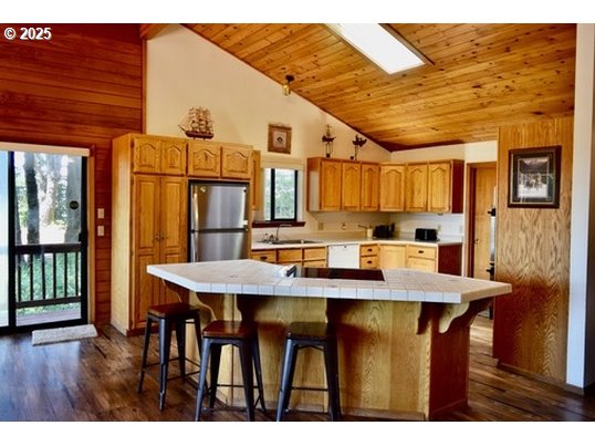 34518 Mutts Way Gold Beach, OR 97444 - Photo 10 of 40 a view of a dining room with furniture and wooden floor