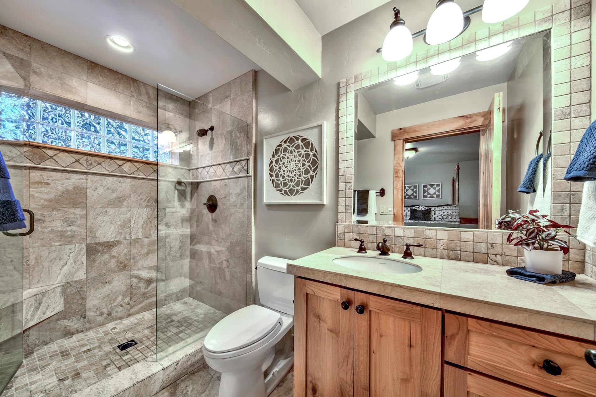 13970 Ski View Loop Truckee, CA 96161 - Photo 20 of 21 a bathroom with a granite countertop sink mirror toilet and shower