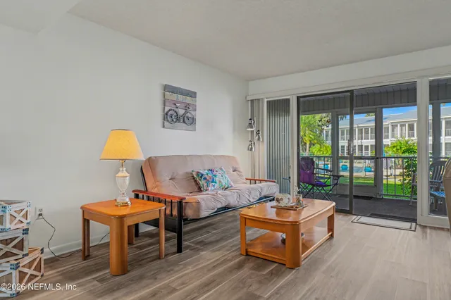 a living room with furniture and a lamp