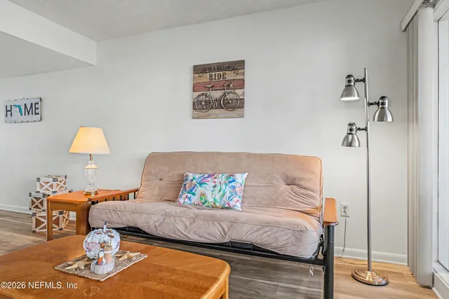 a bedroom with a bed and a lamp on table