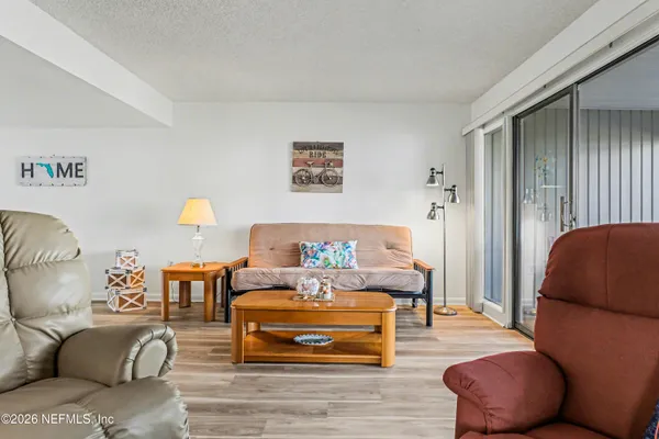 a living room with furniture and a lamp