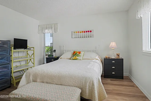 a bedroom with a bed and a tv on the dresser