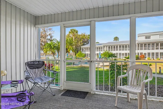 a view of a chair and tables in the balcony