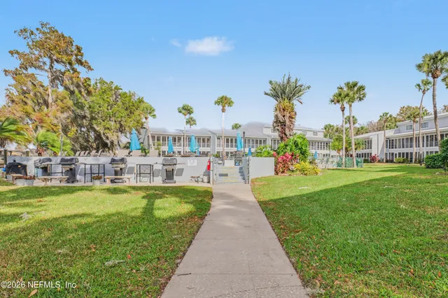 a view of swimming pool with outdoor seating and plants