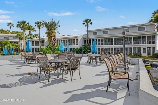 a balcony with furniture and a potted plant