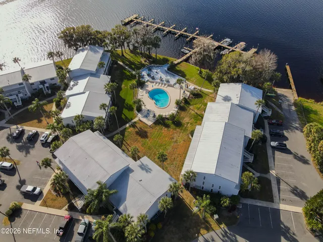 an aerial view of a house a yard and outdoor seating