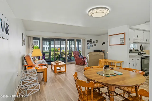 a dining room with furniture and wooden floor